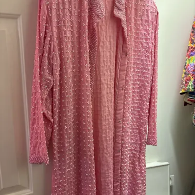 Vintage pink long-sleeved open cardigan jacket featuring intricate white seed bead and pearl grid embroidery throughout.