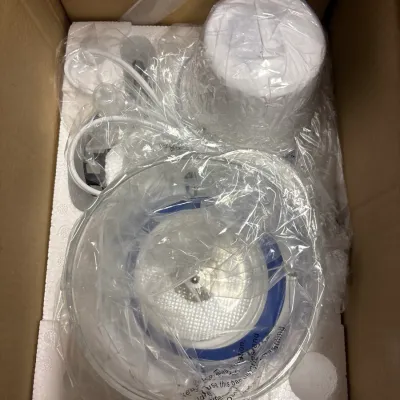 Small kitchen appliance, possibly a juicer or food processor, packed in its original box with protective plastic and styrofoam insert.