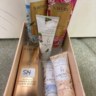 Boxed set of Nakery Beauty skincare products, including body butter tubes, body and hand wash, and Power Blend Elixir Serum in original...