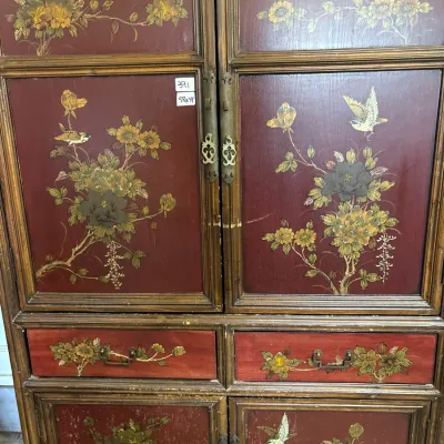 Asian-inspired wooden cabinet featuring hand-painted floral and bird designs on red panels, with decorative brass hardware.
