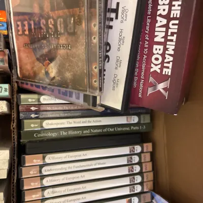 Assortment of DVDs and audio CDs, including titles from The Great Courses series and The Ultimate Brain Box set.