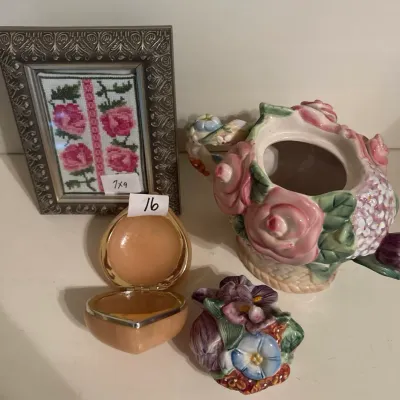 Floral tabletop decor set featuring a framed needlepoint rose print, a heart-shaped stone trinket box, and a ceramic teapot adorned with...