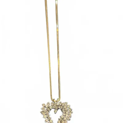 Gold-tone snake chain necklace with an openwork heart pendant set with yellow-tinted rhinestones.