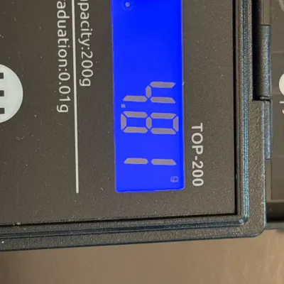 A TOP-200 digital precision scale showing a weight measurement of 4.81 grams on a backlit LCD display.