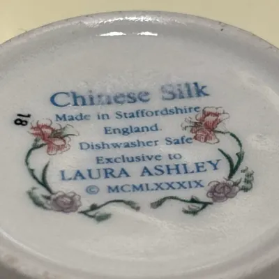 Bottom backstamp detailing the 'Chinese Silk' pattern made in Staffordshire, England, exclusively for Laura Ashley, dated 1989.