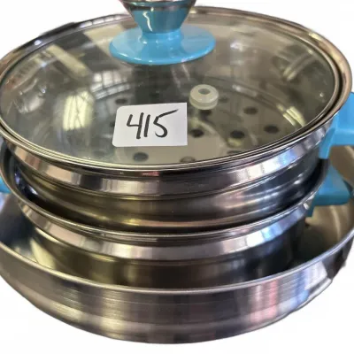 Multi-tier stainless steel steamer pot set with bright blue handles and a clear glass lid.