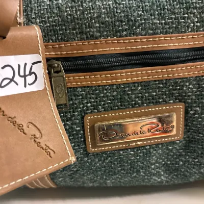 Vintage Oscar de la Renta green woven tweed duffel bag with brown leather trim and original leather hangtag.