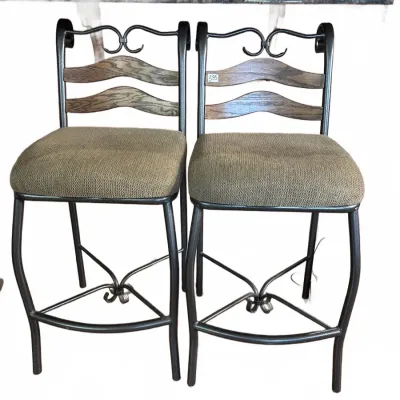 Pair of modern metal and wood bar stools with upholstered seats and scrollwork back details.