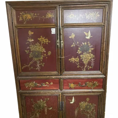 Asian-style hand-painted wooden armoire cabinet featuring floral and bird motifs on burgundy panels with brass hardware.