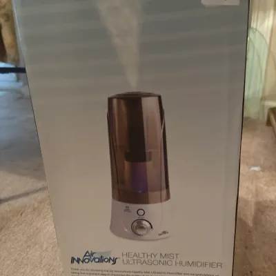 Air Innovations Healthy Mist Ultrasonic Humidifier in its original retail packaging.