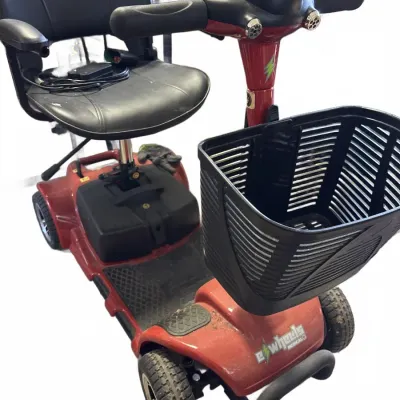 Red EWheels Medical electric mobility scooter, equipped with a black swivel vinyl seat, a front-mounted plastic storage basket, and key...