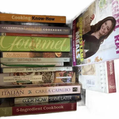 Stack of assorted contemporary cookbooks, including titles from Rachael Ray, Gourmet, and Reader's Digest.