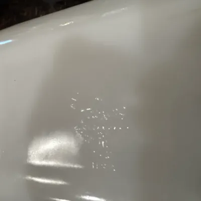 Bottom detail of a vintage Pyrex white milk glass baking dish showing the embossed maker's mark.