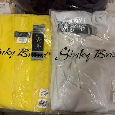 Two new-in-packaging Slinky Brand women's cardigans or tops in bright yellow and white, size 1X.