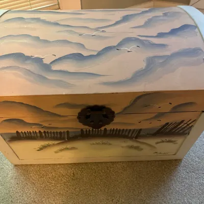 Hand-painted domed wooden storage chest featuring a coastal scene with dunes, seagulls, and clouds.
