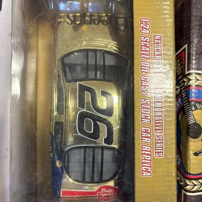 NASCAR Gold Commemorative Series 1:24 scale die-cast stock car replica in original packaging, featuring #26 Cheerios and Betty Crocker...
