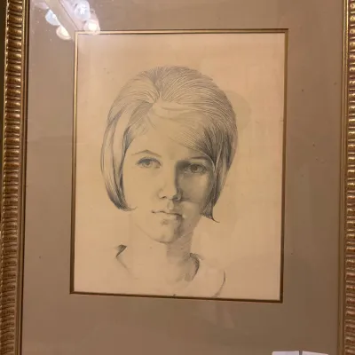 Framed vintage pencil portrait drawing of a young woman with a 1960s hairstyle in a textured gold-tone wood frame.