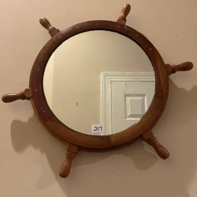 Vintage nautical ship's wheel wall mirror featuring a turned wooden frame with six handles.