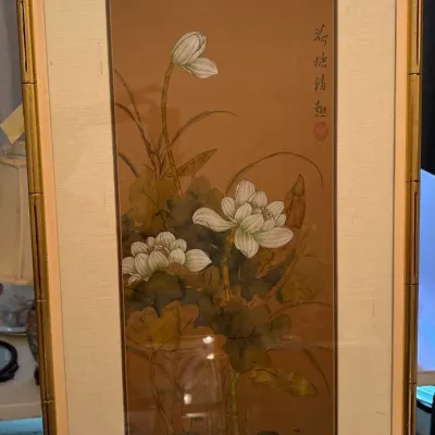 Framed Asian watercolor painting depicting lotus flowers and buds on a silk background, mounted in a gold faux-bamboo frame.