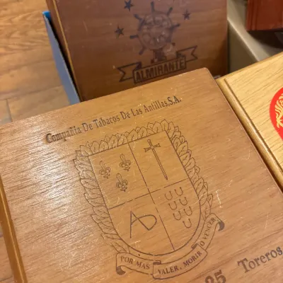 Collection of vintage wooden cigar boxes, including one from Compañia De Tabacos De Las Antillas, S.A., displaying light surface wear.