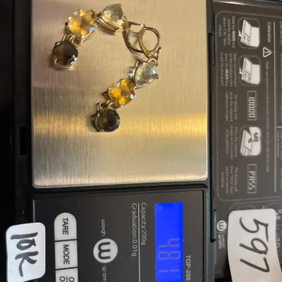 10K yellow gold multi-gemstone bracelet featuring faceted citrine, prasiolite, and smoky quartz stones, weighing 4.81 grams on a digital...