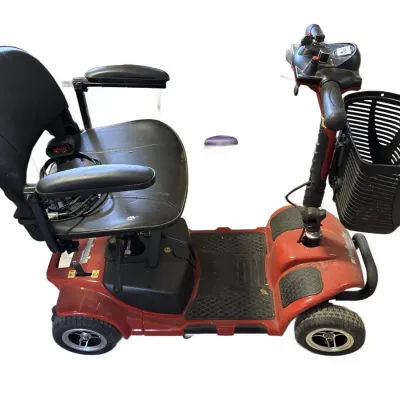 Red four-wheel mobility scooter featuring a black vinyl swivel seat, front storage basket, and adjustable tiller control panel.