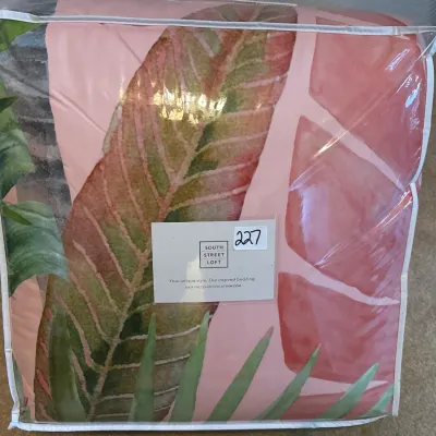 South Street Loft bedding set featuring a tropical leaf pattern in pink and green, packaged in its original zippered plastic case.