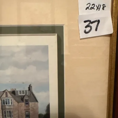Framed architectural art print depicting a stone estate, set in a double mat with a gold-tone frame.