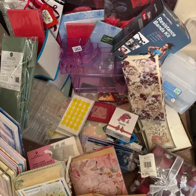 Large assortment of household items, stationery, books, and crafting supplies, including a Bell+Howell resistance bands kit, acrylic...