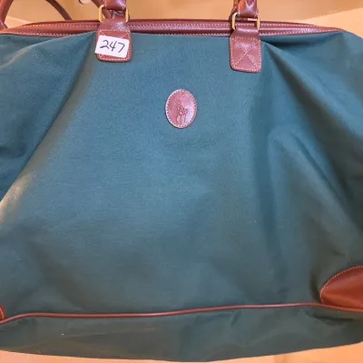 Vintage Polo Ralph Lauren green canvas and brown leather duffel bag featuring an embossed leather logo patch.