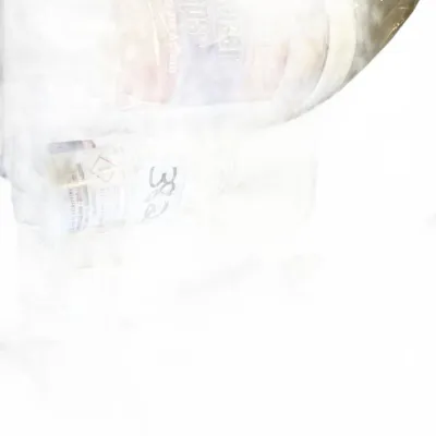 Bagged assortment of cleaning supplies and household items, overexposed in lighting.