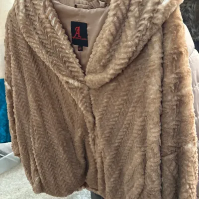 Tan textured faux fur coat featuring a wide shawl collar, size medium, in good condition.