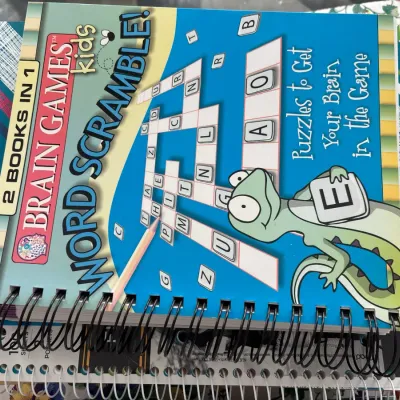 Spiral-bound Brain Games Kids Word Scramble activity book in good condition.