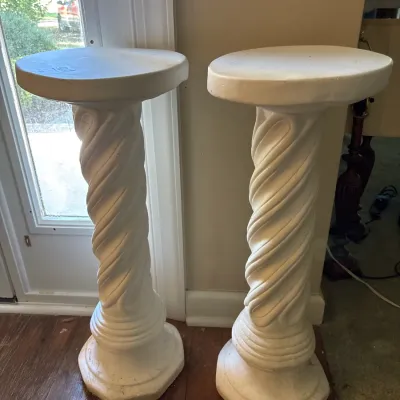 Pair of white plaster twisted spiral pedestal plant stands with round tops and octagonal bases.