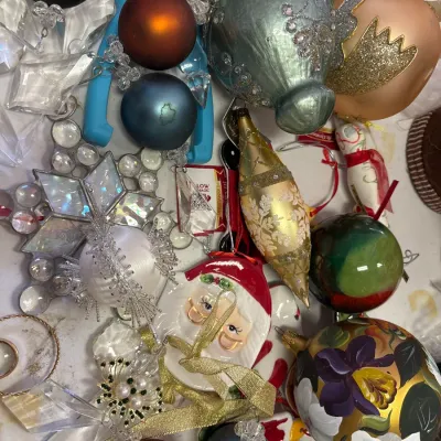 Collection of assorted holiday ornaments, including hand-painted glass baubles, Santa motifs, glittered teardrops, and faceted crystal...