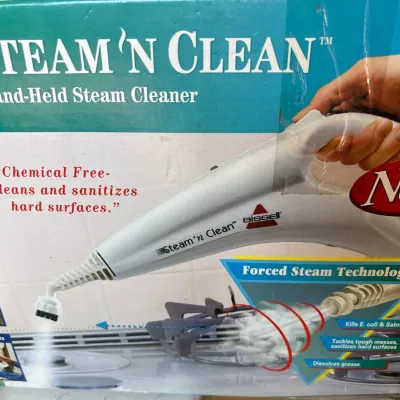 Vintage Bissell Steam 'n Clean hand-held steam cleaner in its original retail packaging.