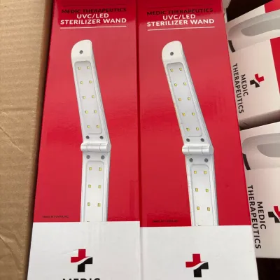 Two new-in-box Medic Therapeutics UVC/LED sterilizer wands in original red and white packaging.