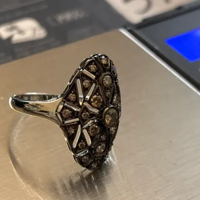 Art Deco style oval cocktail ring set with pave champagne diamonds in a blackened filigree mount.