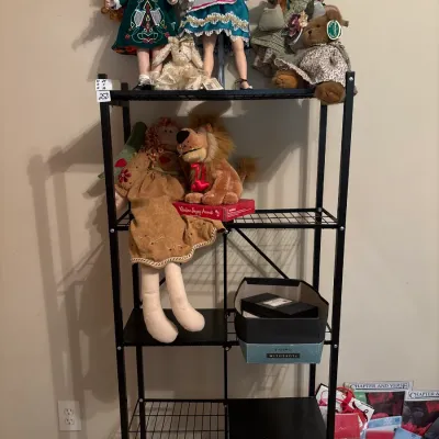 Black metal wire shelving unit displayed with porcelain dolls, plush toys, shoe boxes, and various stationary items.