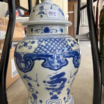 Vintage blue and white porcelain ginger jar featuring intricate floral, lattice, and dragon motifs with a matching pointed lid.