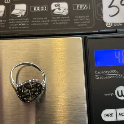 Vintage marcasite cluster ring on a digital scale displaying a weight of 4.83 grams.