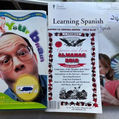 Selection of books including Doug Hall's Jump Start Your Brain, J. Gruber's 2012 Garden and Farm Almanac, and a Great Courses...