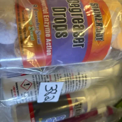 Bagged assortment of Stainz-R-Out cleaning products, including Degreaser Drops and spray bottles.