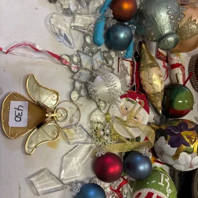 Collection of assorted vintage and modern Christmas ornaments, including glass baubles, crystal prisms, and a wire angel.
