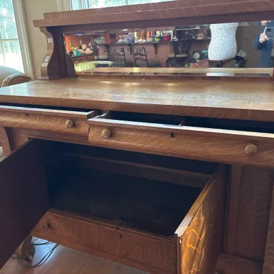 Antique tiger oak sideboard server with mirrored gallery back, top drawers, lower cabinet space, and a bottom drawer.