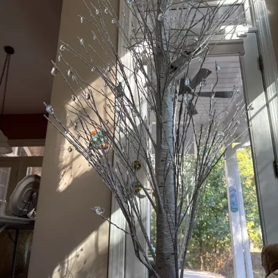 Tall faux white birch decor tree with clear crystal droplets suspended from bare branches.