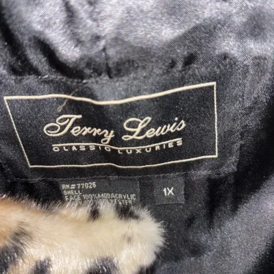 Close-up of a Terry Lewis Classic Luxuries brand label on a size 1X leopard-print faux fur coat.