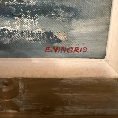 Close-up detail of an artist's signature reading 'E. VINGRIS' in red paint on a framed oil on canvas painting.