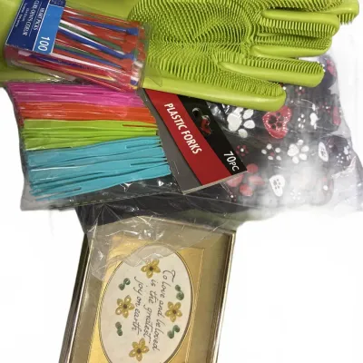 Assortment of household items including green silicone cleaning gloves, packages of plastic forks and picks, and a small framed...