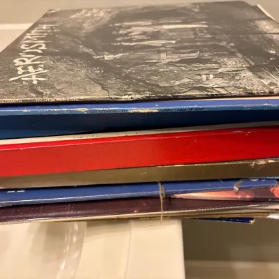 Stack of vintage vinyl LP records, including Aerosmith's "Night in the Ruts" and Cat Stevens' "Tea for the...